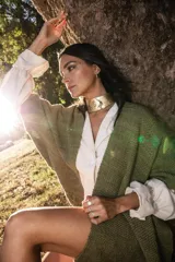 Ruana de lana merino color verde seco, con tejido suave y flecos en el borde.