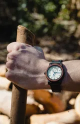 Reloj Chenaut Perle d’Ébène con caja de madera de sándalo rojo, esfera blanca perlada con manecillas azules y malla de madera de ébano.