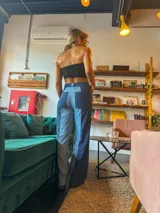 Pantalón jean de tiro alto con corte recto y diseño color block en tonos de azul.