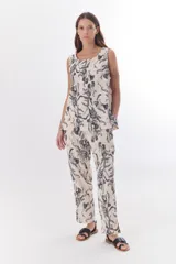 Sandalias planas con estampado animal, hebilla dorada y suela marrón.