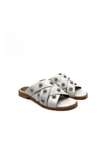 Sandalias blancas de cuero con tiras cruzadas y tachas plateadas.