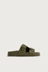 Sandalia de estilo casual en color verde militar con acabado engomado, dos tiras anchas en el empeine ajustables con hebillas y plantilla anatómica.