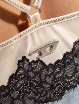 Top Diesel T-Asty de satén color celeste con encaje negro en escote y ruedo, tirantes finos regulables y logo metálico en la espalda.