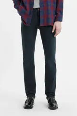 Jean de corte slim fit con tiro medio, confeccionado en denim de color negro con acabado desgastado.