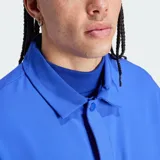 Chaqueta de entrenador de básquet adidas Basketball de corte clásico, color azul, con cierre frontal, cuello tipo camisa, bolsillos laterales con cierre y puños elásticos.