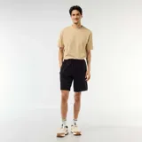 Bermuda de punto piqué estilo deportivo color negro, con cintura elástica ajustable mediante cordón y bolsillos laterales con cierre.