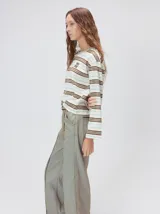 Remera de manga larga con diseño a rayas horizontales en tonos azul, blanco y negro. Presenta un cuello redondo al tono y un logo bordado en el pecho. El diseño destaca por tener un patrón de rayas diferente en las mangas y un calce holgado.