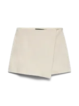 Pollera short de tiro alto y fit holgado, con diseño envolvente en la parte delantera y cierre lateral invisible.