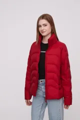 Campera roja de poliéster con diseño acolchado, cierre frontal con cremallera y cuello alto.
