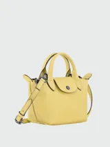 Bolso tipo tote Longchamp Le Pliage Xtra, color amarillo, con doble asa superior y cierre de solapa con botón a presión.