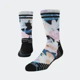 Medias Stance Tendency con estampado de flores en tonos pastel, puño acanalado con tres rayas horizontales negras y logo de la marca en el tobillo.