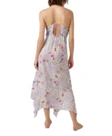 Vestido largo de tirantes finos con estampado floral en tonos lila, rojo y blanco. Presenta escote en V con ribete azul y corte asimétrico en el bajo.