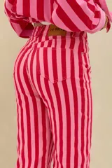 Pantalón de denim de tiro medio con diseño de rayas verticales en tonos rojo y rosado, de corte recto y largo midi.