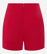 Short pollera corto color marrón de bengalina, con diseño cruzado en el frente, cierre invisible en la parte trasera y talle alto.