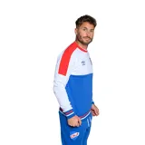 Buzo de fútbol Umbro del Club Nacional de Football, con diseño de bloques de color blanco, azul y rojo. Incluye logo de Umbro y escudo del club.