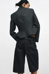 Bermuda de tiro medio confeccionada en denim de algodón, con diseño de cinco bolsillos, trabillas en la cintura y costuras a contraste.