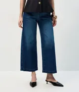 Pantalón de jean de corte wide leg y largo cropped, con cintura alta, cierre frontal y bolsillos funcionales.