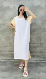 Vestido largo blanco con mangas cortas negras y corte holgado.