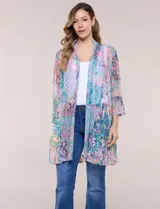 Cardigan largo de tul semitransparente color verde, con estampado patchwork y bordados florales en relieve. Presenta diseño de frente abierto con solapas fluidas y mangas tres cuartos acampanadas.