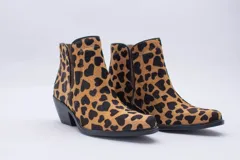 Texana de caña corta con diseño de animal print en color fucsia y negro. Presenta un taco bajo y aberturas laterales.