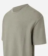 Remera color crema, de corte holgado, con cuello redondo y mangas cortas.