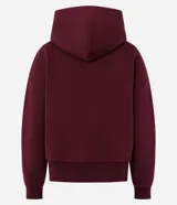 Buzo de algodón con felpa, color bordó, con capucha estructurada, bolsillo canguro delantero y puños canelados.