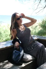 Pollera larga de viscosa, color azul marino con estampado de lunares blancos. Diseño de tiro alto y corte amplio.