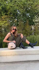 Bandolera pequeña de diseño moderno, confeccionada en tafeta liviana y resistente. Cuenta con cierre superior, correa ancha ajustable y logo frontal de la marca.