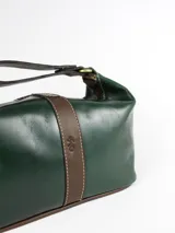 Necessaire de cuero verde con detalles en cuero marrón, cuenta con una manija superior y cierre superior.