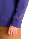 Buzo azul con logo de Caterpillar estampado en amarillo en el pecho y logo triangular en la manga.