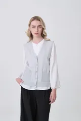 Chaleco de punto gris con escote en V, cierre frontal de botones y dos bolsillos delanteros con terminación acanalada.