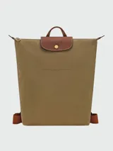 Mochila Longchamp de la línea Le Pliage Original, tamaño M, en color rosado con solapa y asas de cuero marrón.