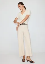 Jeans Catherin de tiro alto, diseño culotte y pernera recta con bajo deshilachado, en color beige. Cuentan con trabillas para cinturón, bolsillos de parche traseros y cierre frontal de cremallera y botón.