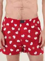 Bóxer de algodón blanco con estampado de flores pequeñas color celeste, con cintura elástica y logo de la marca en el centro.