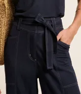 Pantalón verde oliva de piquet con pespuntes a contratono, corte recto, tiro alto y lazo en la cintura.