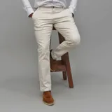 Pantalón de gabardina color azul marino, de corte ajustado y tiro medio, con cierre y botón frontal.