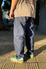 Pantalón de jean azul oscuro con corte baggy y calce relajado. Presenta cinco bolsillos clásicos y costuras reforzadas en tono contrastante.