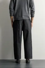 Jeans tapered wide fit de hombre, confeccionados en denim de algodón con efecto lavado en tono azul oscuro. Presentan diseño de cinco bolsillos, tiro medio, corte relajado y cierre frontal con cremallera y botón.