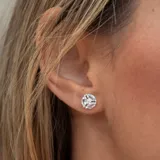 Aros de plata 925 con tres piedras aguamarina y un topacio blanco central.