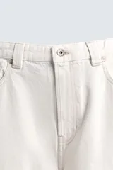 Jeans de denim de algodón color negro, con corte balloon fit relajado desde la cadera y ligeramente estrechado en el bajo. Tiro medio, cinco bolsillos y cierre frontal con cremallera y botón.