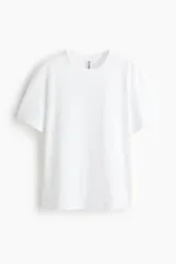 Remera de corte holgado y diseño básico color blanco, confeccionada en punto suave con cuello redondo y hombros caídos.
