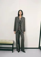 Pantalon recto de tiro alto confeccionado en tejido de mezcla de lana con diseño jaspeado. Cuenta con cierre de cremallera lateral.
