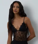 Body Blue Steel femenino confeccionado en encaje transparente, con copa, escote en V, breteles finos ajustables y cierre inferior.
