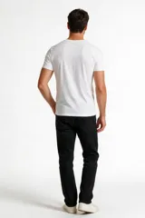 Pantalón jean negro de corte skinny y tiro bajo, con diseño clásico de cinco bolsillos y cierre frontal con botón y cremallera.