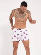 Bóxer de algodón blanco con estampado de flores pequeñas color celeste, con cintura elástica y logo de la marca en el centro.