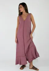 Vestido largo sin mangas, con escote en V, corte holgado y detalles de volados con flecos en el ruedo.