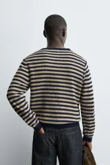 Jersey de punto con diseño de rayas horizontales en azul marino y beige, de corte regular fit. Presenta cuello redondo, manga larga y acabados en rib en cuello, puños y cintura. Confeccionado en tejido de algodón.