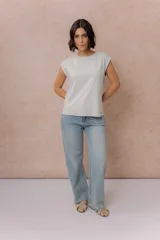 Remera de algodón color crema, con cuello redondo y mangas cortas con dobladillo vuelto. Presenta un corte relajado y estructura en los hombros.