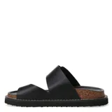 Sandalias Miss Carol modelo Melak de color beige, con tira ancha ajustable mediante una hebilla metálica grande y presilla para el dedo. Cuenta con suela de corcho y base de goma negra.