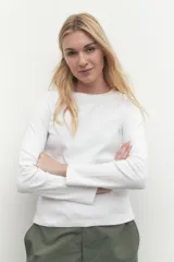Remera de manga larga color blanco, con cuello redondo y calce al cuerpo.